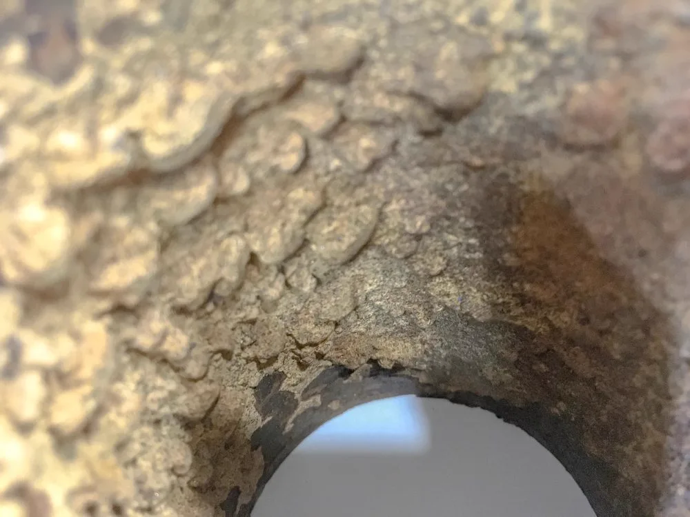 Looking into the mouth of an old degraded pipe before pipe relining